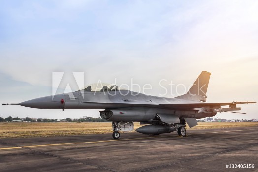Bild på f16 falcon fighter jet military aircraft parked in the runway on sunset  